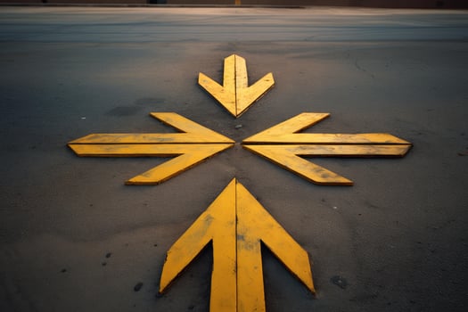 Yellow arrows pointing in different directions on asphalt road photo