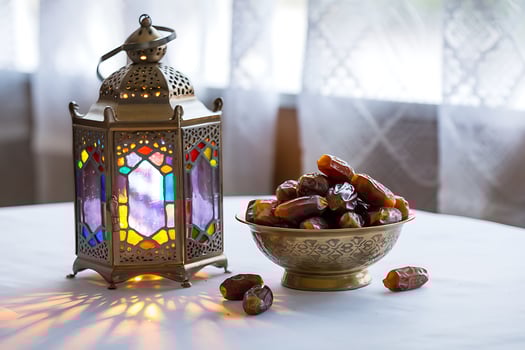 A colorful lantern and a bowl of dates photo