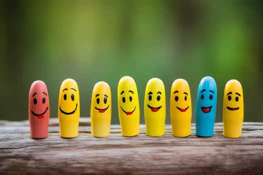 Colorful wooden figures showing different emotions stand on a wooden surface photo