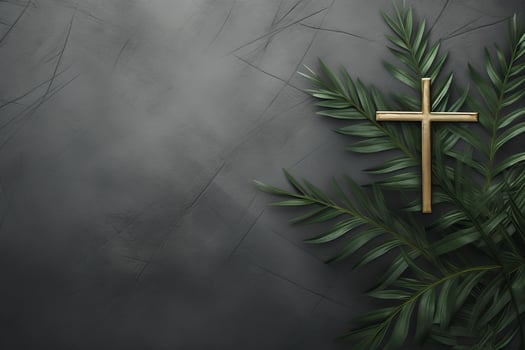 Golden christian cross resting on palm leaves against dark background photo