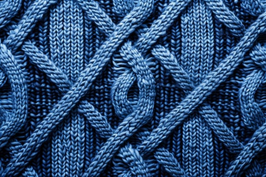 Blue knitted cable pattern showing intertwined yarn strands creating warm winter clothing photo