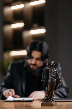 Statue of Justice with scales and a lawyer working on a laptop. Concept legal consultations and decision-making using modern technology for efficient legal solutions photo