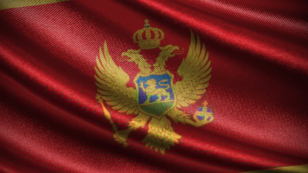 Montenegro flag with realistic silky wave texture photo