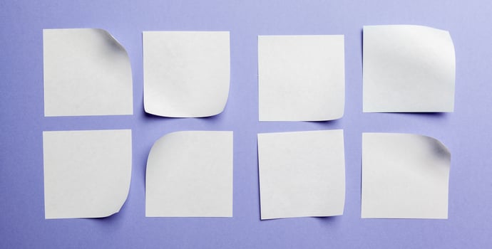 Blank paper tag label or sticker with copy space - flat lay on violet desktop background photo