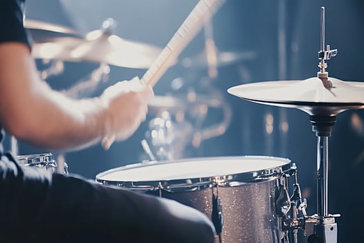 Drummer playing drums during a concert on stage photo