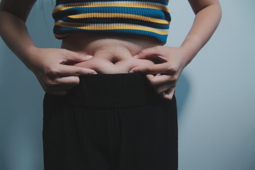 A woman with her hands on her stomach photo