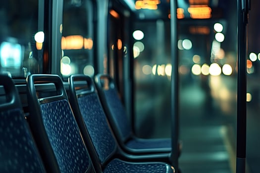 Empty bus seats driving through city at night photo