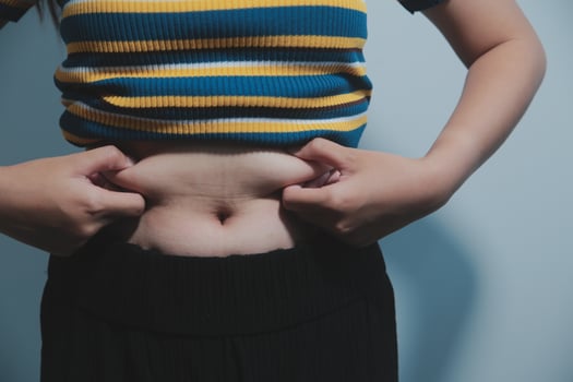 A woman with her hands on her stomach photo
