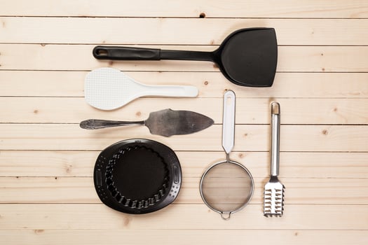 cookware and accessories on a wooden table. photo