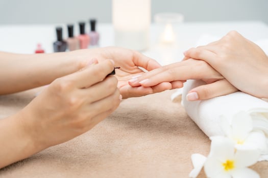 Woman receive care service by professional Beautician Manicure at spa centre. Nail beauty salon use nail file for Glazing treatment. manicurist make nail customer photo