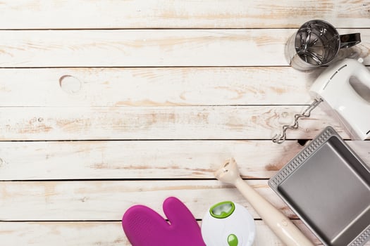 Various kitchen utensils on wooden table photo
