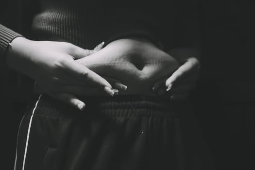 A black and white photo of a woman's stomach