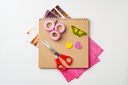 Crafting materials arranged for a colorful creative project on a white background photo