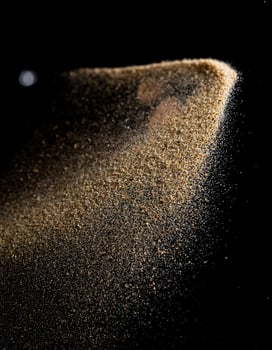 Natural Brown Sand Spread on Black Background, Minimalist Concept photo