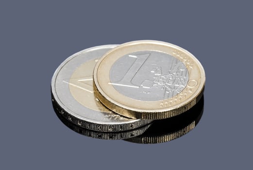 Coins of one and two Euro on a gray background closeup photo