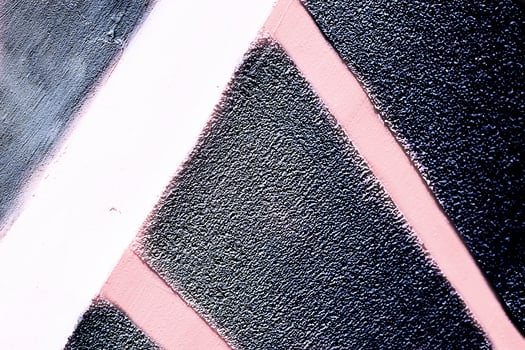 Black stucco wall surface with pink white stripes photo