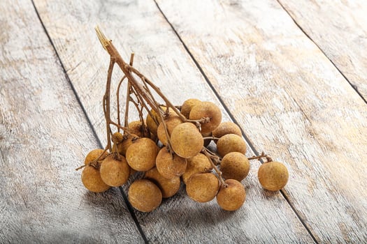 A bunch of fruit on a wooden table photo