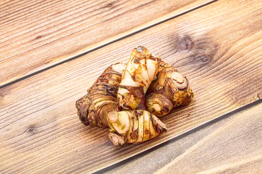 A pile of ginger on a wooden table photo