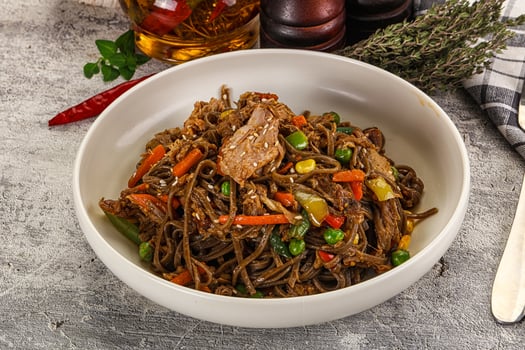 A bowl of noodles with meat and vegetables photo