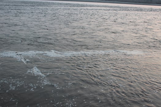 A person is flying a kite in the water photo