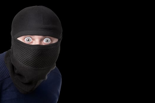 man in balaclava on black photo