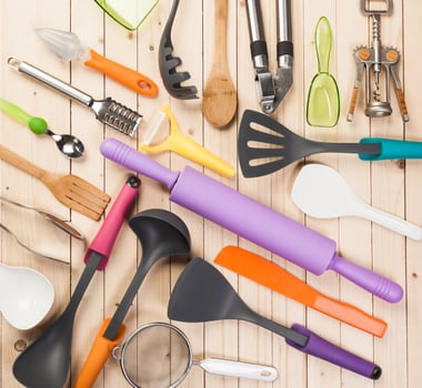 cookware and accessories on a wooden table. photo