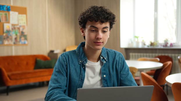 Caucasian male student guy pupil boy teen teenager studying laptop learning computer using pc study learn online education internet course homework prepare to exams school academy college university photo