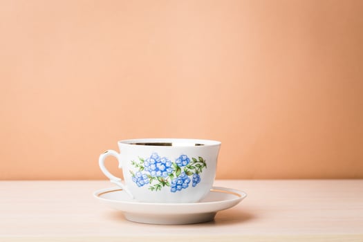 Cup of black tea in a china cup and saucer photo