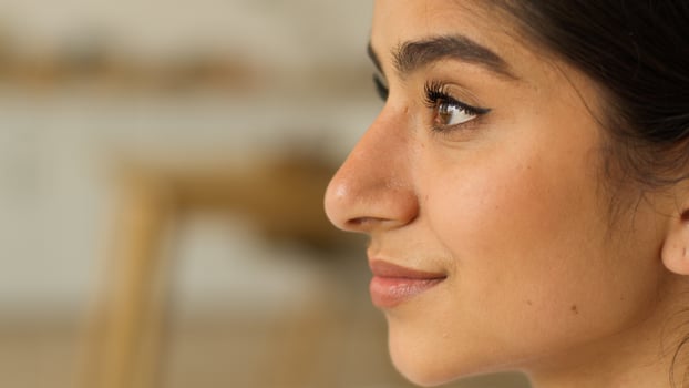Female profile face head portrait from side Indian woman Arabian girl lady indoors at home looking at front smiling happy smile positive dreaming cosmetology healthy skin dermatology cosmetic health photo