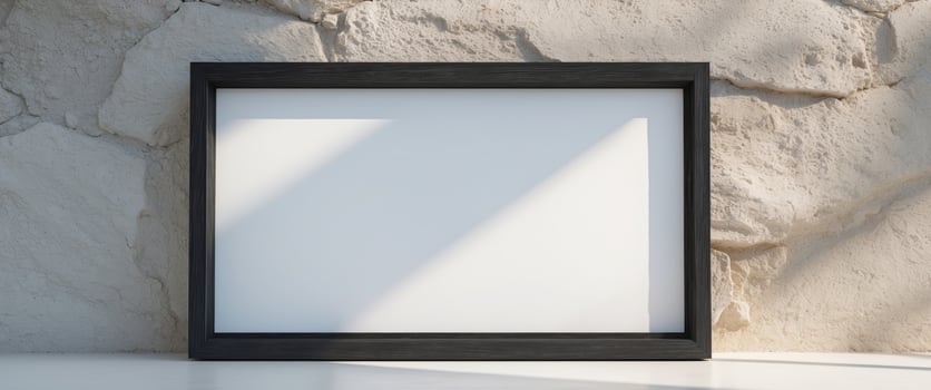A wooden black frame with a white matte on a textured wall. photo