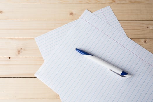 close-up of ball point pen over lined paper photo