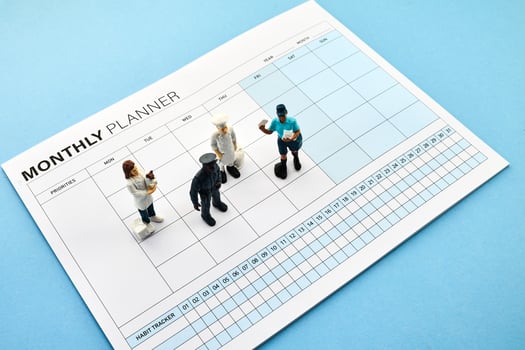 Concept of four-day work week. Printed calendar for a 4 day working week. Mini Figures on Planner photo
