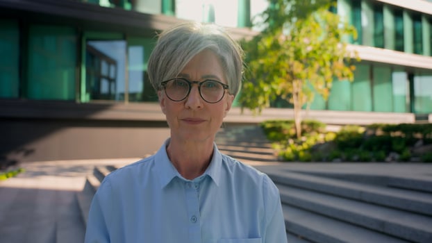 Close up portrait confident serious Caucasian 60s middle aged old business woman in glasses CEO director executive manager looking at camera in city female businesswoman entrepreneur headshot outdoors photo