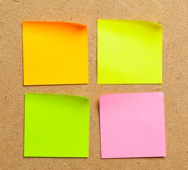Color sticker notes over cork board background photo
