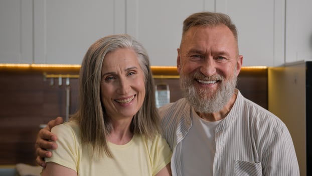 Retired Caucasian happy smiling married couple family gray haired grandma and grandpa wife and husband portrait middle-aged senior mature old man and woman in love hugging in kitchen health insurance photo