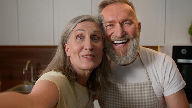 Webcam view happy senior retired family couple chefs record recipe food blog in kitchen old Caucasian grandparents woman and man talk live stream culinary hobby healthy eating love relationship photo