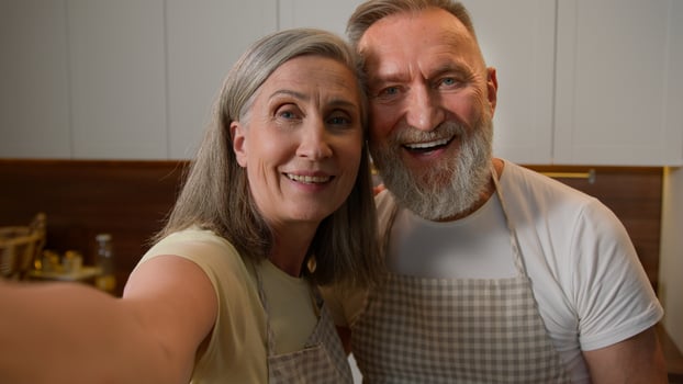 Webcam view happy senior retired family couple chefs record recipe food blog in kitchen old Caucasian grandparents woman and man talk live stream culinary hobby healthy eating love relationship photo