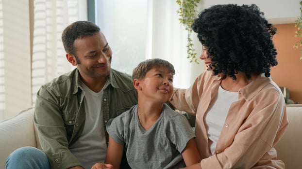 African American mother and father loving mum dad family portrait multiracial couple parents and Caucasian adopted child kid looking at each other smiling hug adorable cute little boy son childcare photo