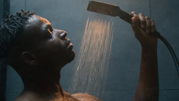 African American man wash wet naked body muscular ethnic guy sexual guy male model washing in shower splashing warm hot water morning hygiene cleaning in bathroom moisture hygienic procedure bodycare photo