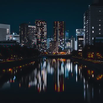 A city at night with a river and buildings photo
