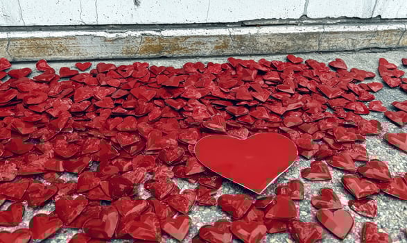A collection of red heart decorations on the ground photo
