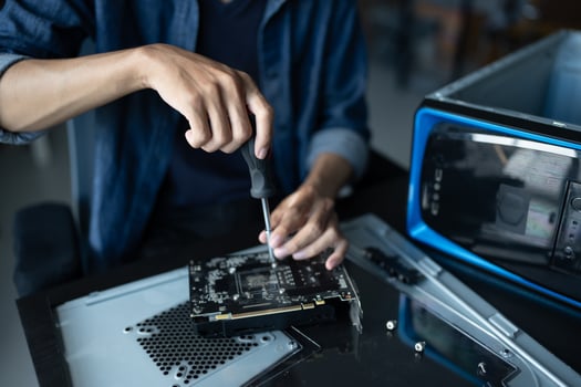 IT Engineer installing Hardware working on a computer with a screwdriver. photo