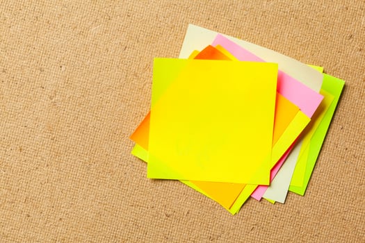 Color sticker notes over cork board background photo