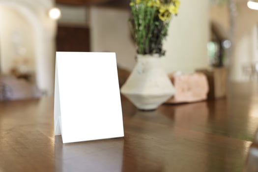blank card mockup on table in restaurant photo