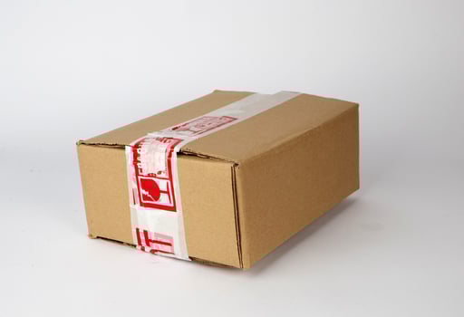 Brown cardboard box isolated on white background with tape photo