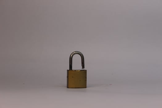 A small padlock on a white surface photo