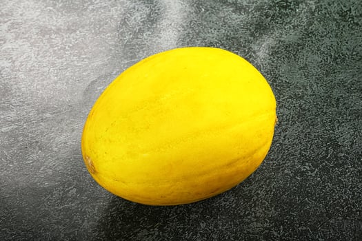 A yellow fruit on a table photo