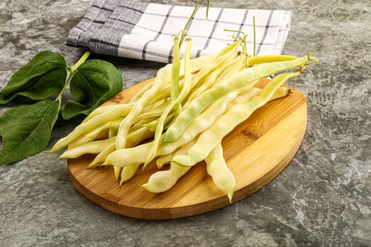 A bunch of beans on a wooden cutting board photo