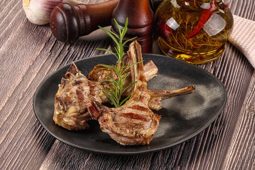 A plate of meat on a wooden table photo
