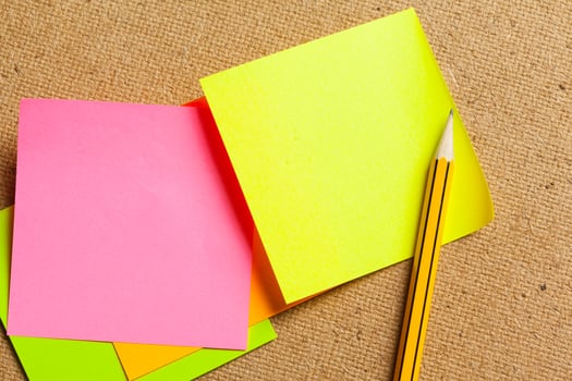 Color sticker notes over cork board background photo